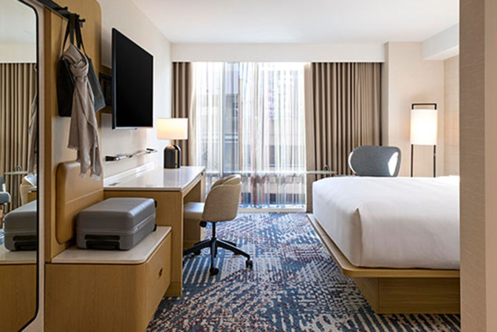 Delta Hotels room with bed, desk, and TV